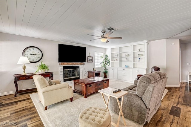 2036 Deer Springs Dr, Henderson, NV 89074 - living room with wood finished floors, a glass covered fireplace, a ceiling fan, wood ceiling, and baseboards