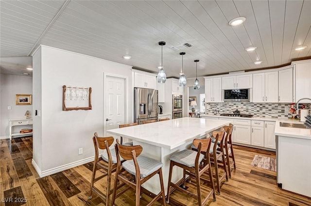 2036 Deer Springs Dr, Henderson, NV 89074 - kitchen featuring appliances with stainless steel finishes, a sink, a breakfast bar area, recessed lighting, and white cabinets