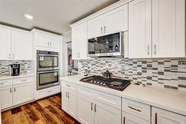 2036 Deer Springs Dr, Henderson, NV 89074 - kitchen with stainless steel appliances, tasteful backsplash, light countertops, white cabinetry, and recessed lighting