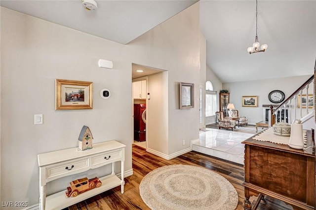 2036 Deer Springs Dr, Henderson, NV 89074 - foyer entrance featuring wood finished floors, a chandelier, baseboards, high vaulted ceiling, and stairway