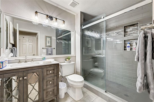 2036 Deer Springs Dr, Henderson, NV 89074 - bathroom featuring toilet, vanity, a shower stall, tile patterned floors, and a textured ceiling