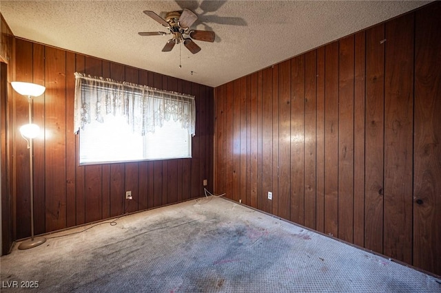 4516 E Flamingo Rd, Las Vegas, NV 89121 - carpeted spare room featuring a ceiling fan, wooden walls, and a textured ceiling