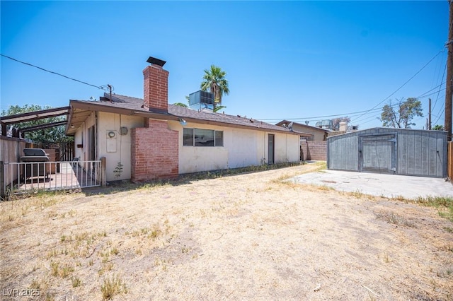 4516 E Flamingo Rd, Las Vegas, NV 89121 - rear view of house with a chimney and central AC