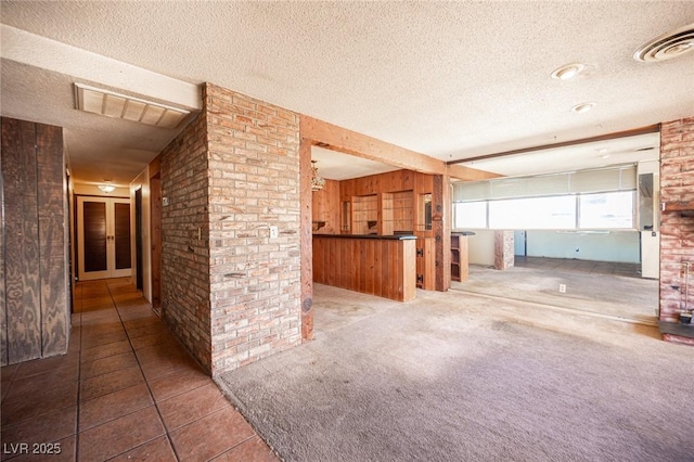 4516 E Flamingo Rd, Las Vegas, NV 89121 - unfurnished living room featuring a textured ceiling and tile patterned flooring