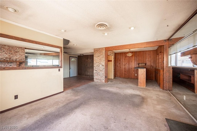 4516 E Flamingo Rd, Las Vegas, NV 89121 - unfurnished living room with wooden walls, light colored carpet, and baseboards