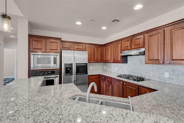 87 E Agate Ave Unit 403, Las Vegas, NV 89123 - kitchen featuring stainless steel appliances, a sink, under cabinet range hood, light stone countertops, and decorative backsplash