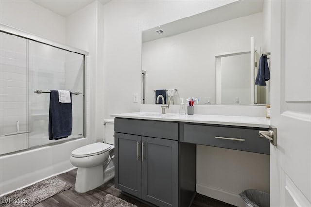 3024 River Brook Ct, Las Vegas, NV 89139 - bathroom featuring vanity, wood finished floors, toilet, and bath / shower combo with glass door