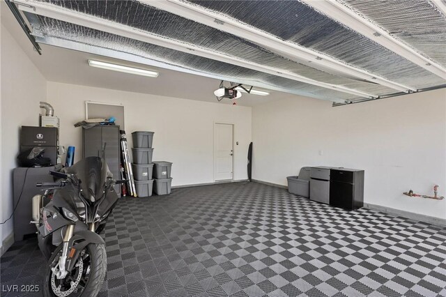 3024 River Brook Ct, Las Vegas, NV 89139 - garage featuring a garage door opener and baseboards