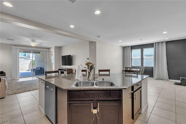 9950 Coyote Echo Ct, Las Vegas, NV 89166 - kitchen featuring open floor plan, a center island with sink, light tile patterned flooring, stone counters, and recessed lighting