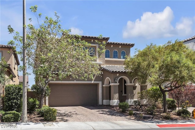 9950 Coyote Echo Ct, Las Vegas, NV 89166 - mediterranean / spanish-style home with a garage, a tiled roof, stucco siding, and driveway
