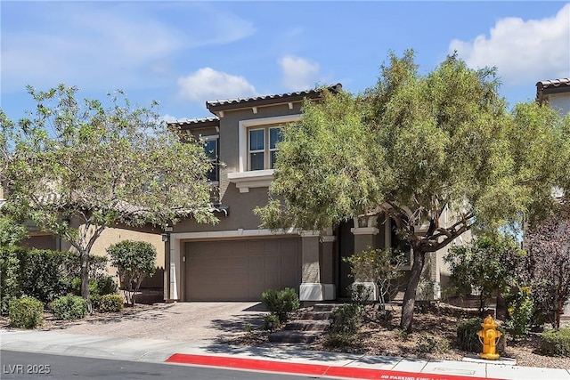 9950 Coyote Echo Ct, Las Vegas, NV 89166 - view of front facade featuring stucco siding, a garage, driveway, and a tiled roof