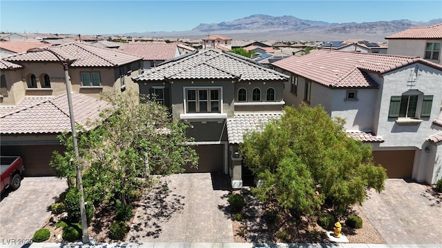 9950 Coyote Echo Ct, Las Vegas, NV 89166 - view of front of house featuring a residential view, a tiled roof, stucco siding, decorative driveway, and a mountain view