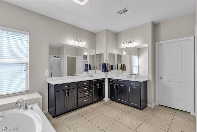 9950 Coyote Echo Ct, Las Vegas, NV 89166 - bathroom with a shower stall, double vanity, tile patterned flooring, and a garden tub