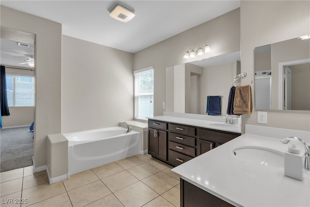 9950 Coyote Echo Ct, Las Vegas, NV 89166 - bathroom with double vanity, healthy amount of natural light, tile patterned floors, and a bath