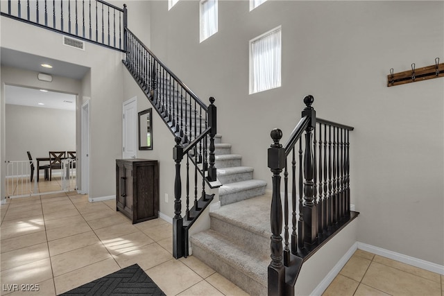 9950 Coyote Echo Ct, Las Vegas, NV 89166 - stairs with tile patterned flooring and a high ceiling