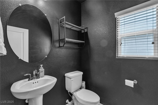 9950 Coyote Echo Ct, Las Vegas, NV 89166 - half bathroom with toilet and a textured wall