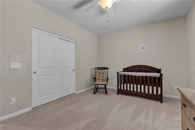 9950 Coyote Echo Ct, Las Vegas, NV 89166 - bedroom with carpet, a nursery area, a ceiling fan, and a closet