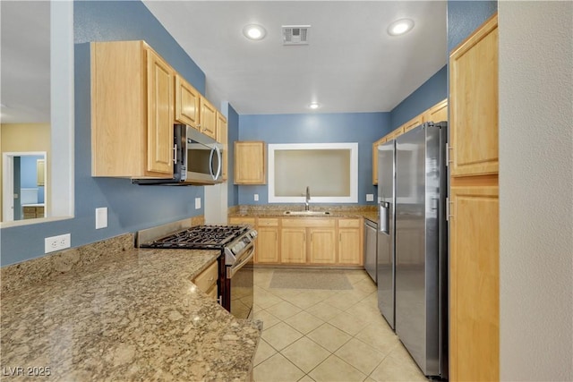 108 Lemon Glaze St Unit 202, Las Vegas, NV 89145 - kitchen featuring appliances with stainless steel finishes, light brown cabinets, a sink, light tile patterned flooring, and light stone countertops