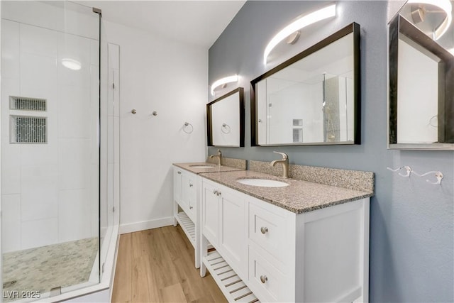 108 Lemon Glaze St Unit 202, Las Vegas, NV 89145 - bathroom with double vanity, a stall shower, wood finished floors, and baseboards