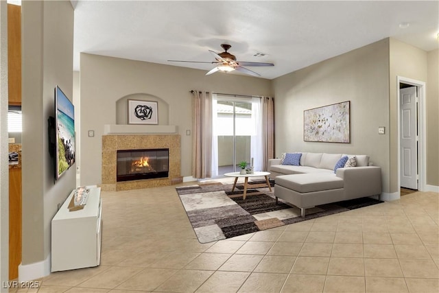 108 Lemon Glaze St Unit 202, Las Vegas, NV 89145 - living room featuring light tile patterned floors, a ceiling fan, baseboards, and a fireplace