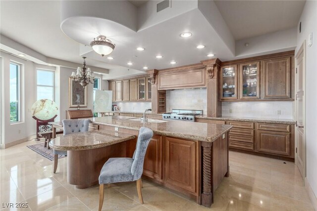9101 Alta Dr Unit 203, Las Vegas, NV 89145 - kitchen featuring stove, backsplash, a kitchen bar, a large island, and recessed lighting