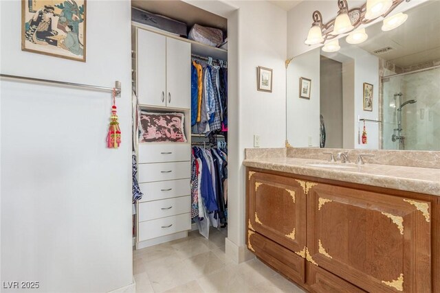 9101 Alta Dr Unit 203, Las Vegas, NV 89145 - full bathroom featuring a stall shower, vanity, a walk in closet, tile patterned floors, and baseboards