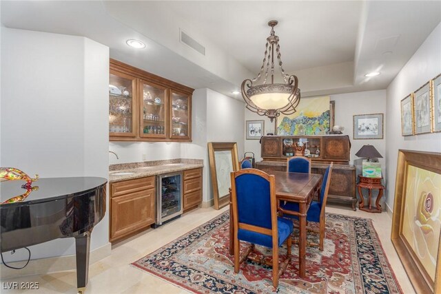 9101 Alta Dr Unit 203, Las Vegas, NV 89145 - dining area with beverage cooler, bar with sink, recessed lighting, and baseboards