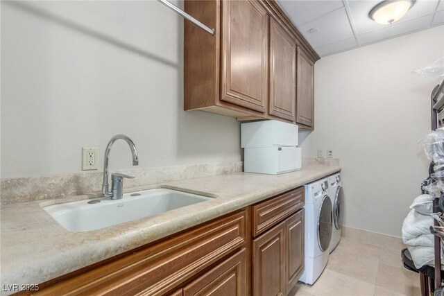 9101 Alta Dr Unit 203, Las Vegas, NV 89145 - laundry area featuring washing machine and dryer, cabinet space, and light tile patterned floors