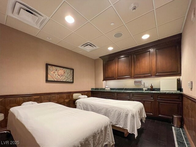9101 Alta Dr Unit 203, Las Vegas, NV 89145 - bedroom with wainscoting, dark wood-style floors, recessed lighting, and a paneled ceiling