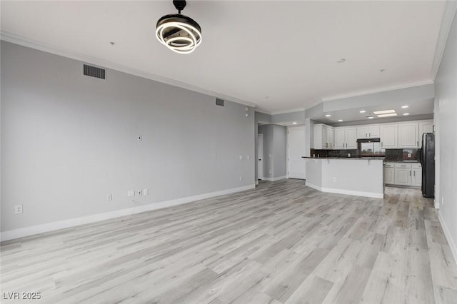 27 E Agate Ave Unit 505, Las Vegas, NV 89123 - unfurnished living room with crown molding, light wood-type flooring, baseboards, and recessed lighting