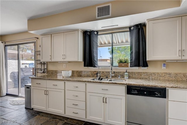 9333 Dry Dock Dr, Las Vegas, NV 89117 - kitchen with stainless steel dishwasher, plenty of natural light, a sink, and white cabinetry