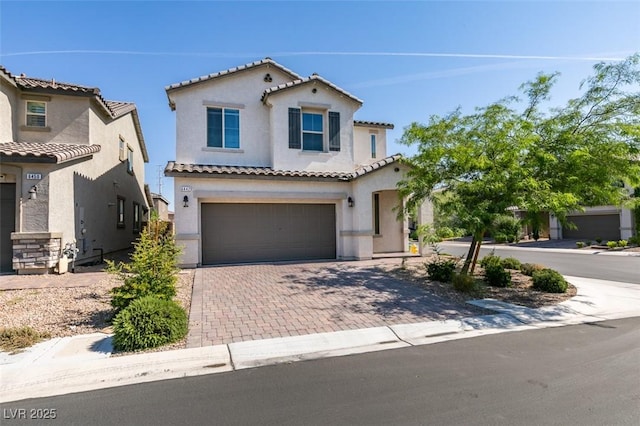 6442 Kobe Knoll Ct, Las Vegas, NV 89141 - mediterranean / spanish-style house with stucco siding, decorative driveway, an attached garage, and a tiled roof