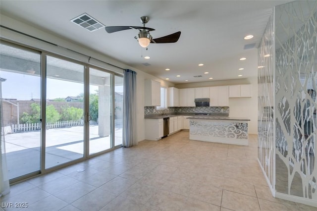 6442 Kobe Knoll Ct, Las Vegas, NV 89141 - kitchen featuring white cabinetry, dishwasher, decorative backsplash, a ceiling fan, and a kitchen island