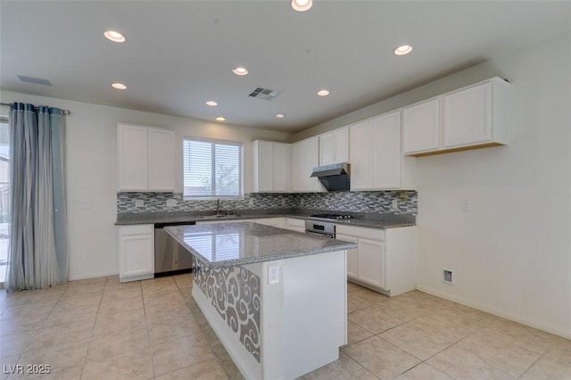 6442 Kobe Knoll Ct, Las Vegas, NV 89141 - kitchen featuring stainless steel dishwasher, tasteful backsplash, white cabinets, a kitchen island, and recessed lighting