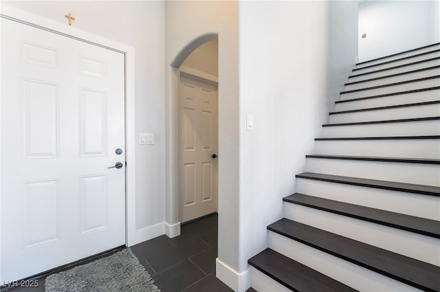 7288 Quarterhorse Ln, Las Vegas, NV 89148 - foyer entrance featuring arched walkways, stairway, and dark tile patterned floors