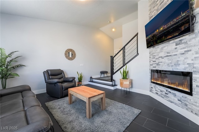 7288 Quarterhorse Ln, Las Vegas, NV 89148 - tiled living room featuring a glass covered fireplace and vaulted ceiling