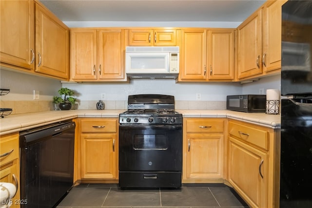 7288 Quarterhorse Ln, Las Vegas, NV 89148 - kitchen featuring black appliances, tile counters, and dark tile patterned flooring