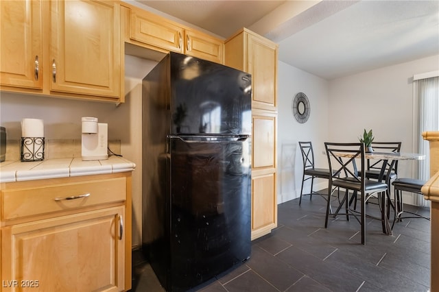 7288 Quarterhorse Ln, Las Vegas, NV 89148 - kitchen featuring freestanding refrigerator, light brown cabinets, tile countertops, and dark tile patterned flooring
