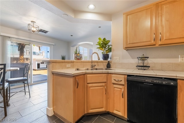 7288 Quarterhorse Ln, Las Vegas, NV 89148 - kitchen with dishwasher, arched walkways, a peninsula, recessed lighting, and tile counters