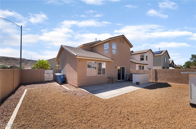7288 Quarterhorse Ln, Las Vegas, NV 89148 - rear view of property with a patio, a fenced backyard, stucco siding, and a tiled roof