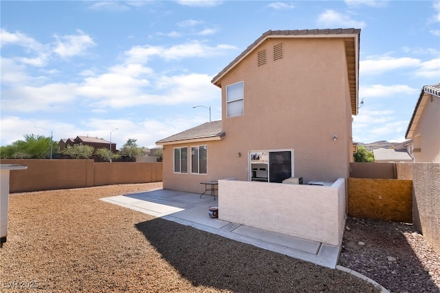 7288 Quarterhorse Ln, Las Vegas, NV 89148 - back of house with stucco siding, a fenced backyard, and a patio