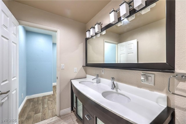 4428 Los Reyes Ct, Las Vegas, NV 89121 - bathroom with double vanity, wood finished floors, and baseboards