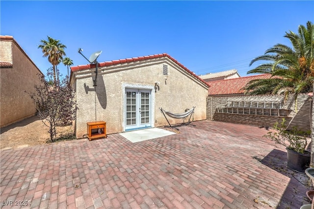 4428 Los Reyes Ct, Las Vegas, NV 89121 - back of property featuring stucco siding, french doors, a patio area, and a tile roof