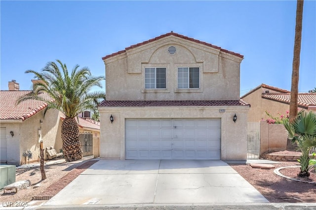 4428 Los Reyes Ct, Las Vegas, NV 89121 - view of front of house featuring an attached garage, concrete driveway, stucco siding, and a tile roof