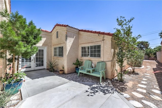 4428 Los Reyes Ct, Las Vegas, NV 89121 - rear view of property with french doors, a patio, stucco siding, and a tile roof