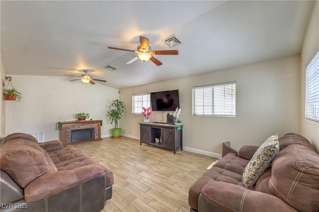 4428 Los Reyes Ct, Las Vegas, NV 89121 - living room with a ceiling fan, light wood-style floors, a fireplace, baseboards, and lofted ceiling