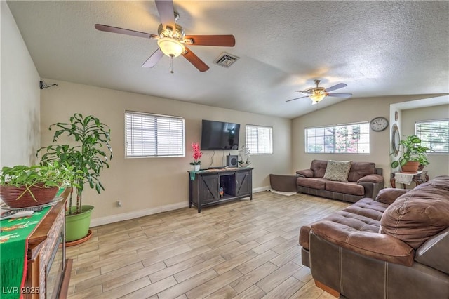 4428 Los Reyes Ct, Las Vegas, NV 89121 - living room with ceiling fan, healthy amount of natural light, a textured ceiling, lofted ceiling, and light wood-type flooring
