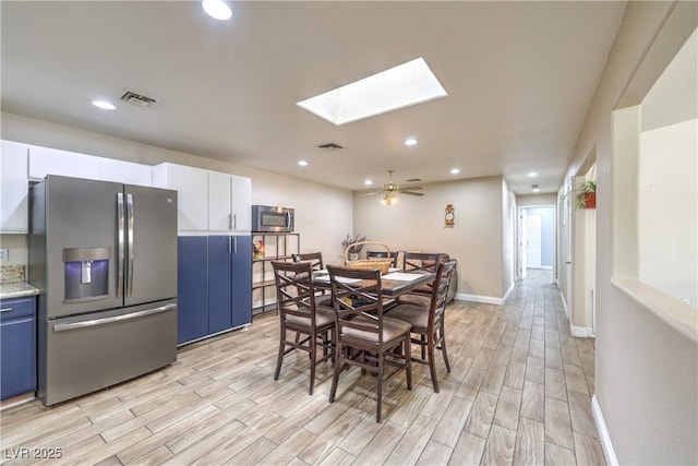 4428 Los Reyes Ct, Las Vegas, NV 89121 - dining room featuring light wood-style floors, a skylight, recessed lighting, and baseboards