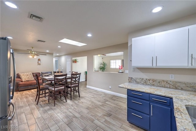 4428 Los Reyes Ct, Las Vegas, NV 89121 - dining room with baseboards, ceiling fan, light wood-type flooring, recessed lighting, and a skylight