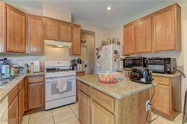 9091 Jumping Jacks Ave, Las Vegas, NV 89178 - kitchen featuring white appliances, under cabinet range hood, light tile patterned flooring, a kitchen island, and recessed lighting